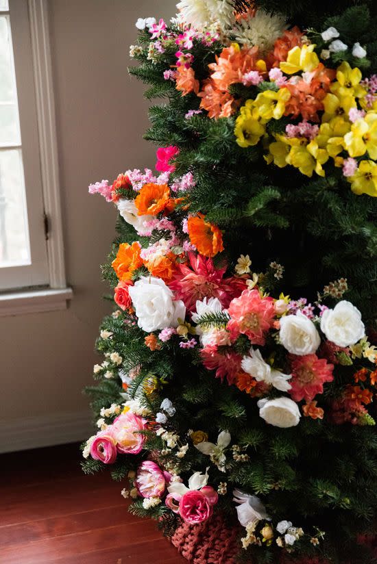 <p>If you're skeptical about replacing your traditional lights and ornaments, try this gorgeous floral wrap on a smaller second tree. Just cut down silk flower stems and stick them in—the more the merrier. Learn how to recreate this garland at <a href="http://www.designlovefest.com/2015/12/diy-floral-tree/#comments" rel="nofollow noopener" target="_blank" data-ylk="slk:Design Love Fest;elm:context_link;itc:0;sec:content-canvas" class="link ">Design Love Fest</a>.</p>