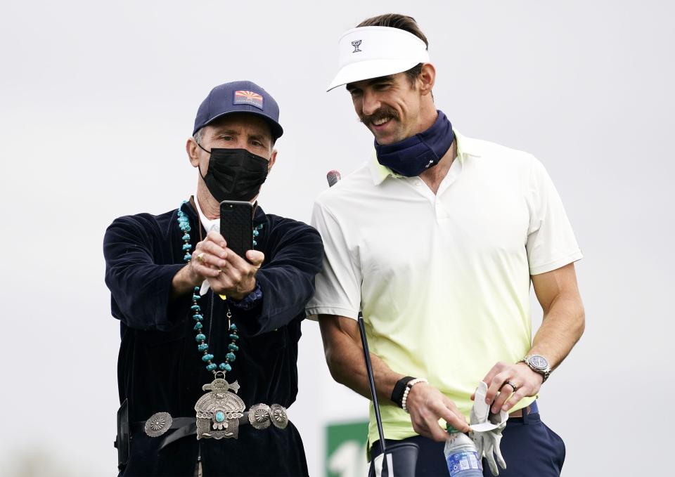 Thunderbird Ray Artigue takes a selfie with Olympian Michael Phelps on the 10th tee box during the Annexus Pro-Am at the 2021 Waste Management Phoenix Open at TPC Scottsdale.