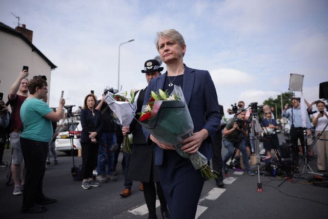 Home Secretary Yvette Cooper holding a bouquet