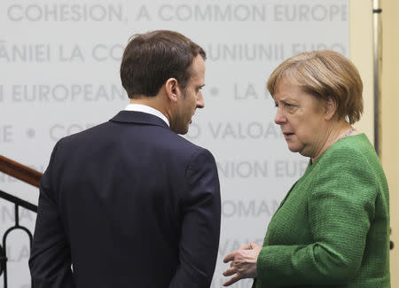 France's President Emmanuel Macron and German Chancellor Angela Merkel speak during the informal meeting of European Union leaders in Sibiu, Romania, May 9, 2019. Ludovic Marin/Pool via REUTERS