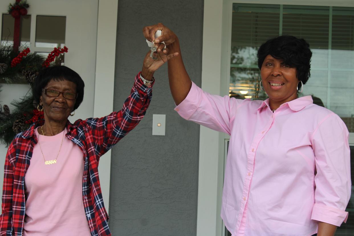 Consuela Green (right), holds keys to new home with mother in welcoming ceremony on Nov. 22 in Belle Glade.