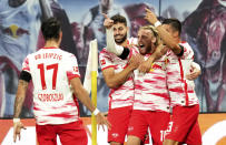 Leipzig's Emil Forsberg, second right, celebrates with teammates after scoring his sides second goal during the German Bundesliga soccer match between RB Leipzig and VfB Stuttgart in Leipzig, Germany, Friday, Aug. 20, 2021. (AP Photo/Michael Sohn)