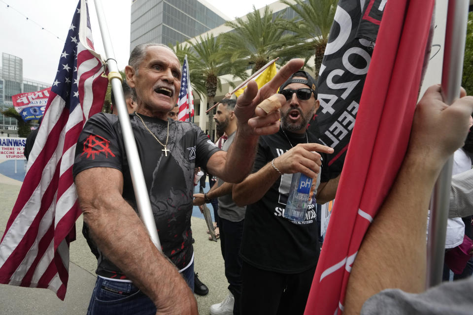 Former President Donald Trump supporters engage with members of Democratic Party of Orange County holding a rally where the 2023 Fall California Republican Convention is being held in Anaheim, Calif., Friday, Sept. 29, 2023. (AP Photo/Damian Dovarganes)