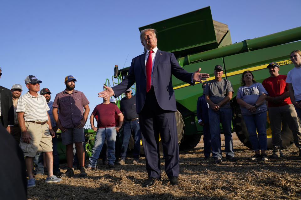 FILE - Former President Donald Trump speaks to reporters during a visit to the Vande Voort family farm, Sunday, Oct. 1, 2023, in Leighton, Iowa. Trump is pushing his supporters to deliver a blowout win in the Iowa caucuses one month away. Unlike his first time in the caucuses, Trump’s campaign is now run by Iowa veterans who are not just locking in caucus commitments but building a formidable organization to try to lock in his lead. (AP Photo/Charlie Neibergall, File)