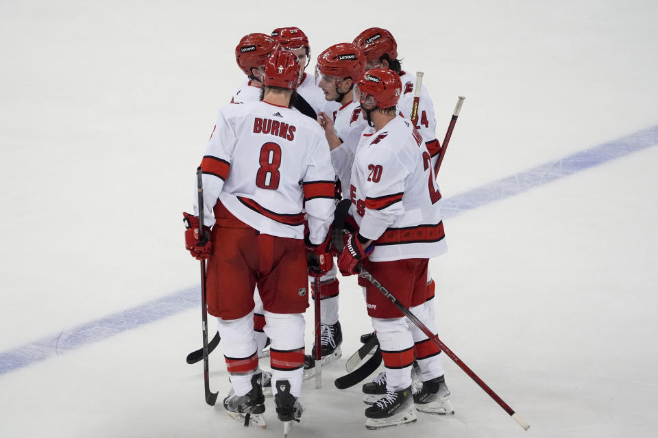 Carolina Hurricanes defenseman Brent Burns (8), center Sebastian Aho (20), center Seth Jarvis (24), defenseman Brady Skjei (76), center Jake Guentzel (59) and right wing Andrei Svechnikov (37) huddle during the third period against the New York Rangers in Game 1 of an NHL hockey Stanley Cup second-round playoff series, Sunday, May 5, 2024, in New York. (AP Photo/Julia Nikhinson)