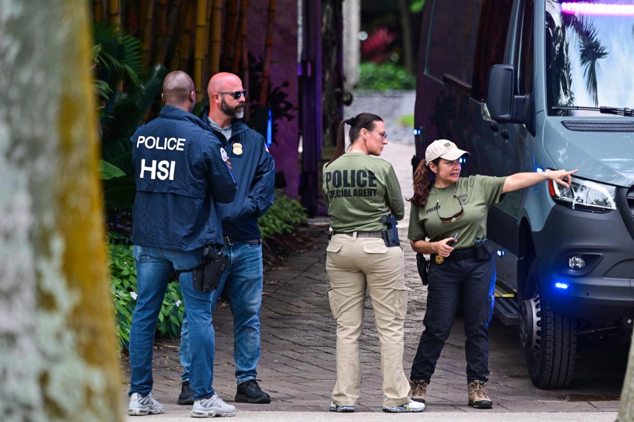Federal and Homeland Security Investigation agents are seen at the entrance of Sean "Diddy" Combs's home at Star Island in Miami Beach, Florida, on March 25, 2024.