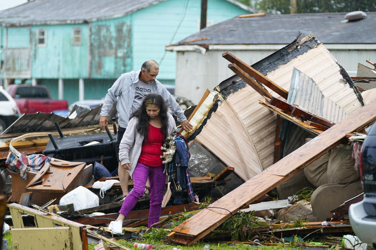 People salvage items from a home after a tornado hit Saturday, May 13, 2023, in the unincorporated community of Laguna Heights, Texas near South Padre Island. Authorities say one person was killed when a tornado struck the southernmost tip of Texas on the Gulf coast. (AP Photo/Julio Cortez)