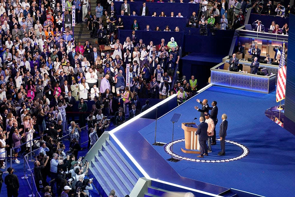 Members of the exonerated Central Park 5, Yusef Salaam, Korey Wise, Raymond Santana, and Kevin Richardson are introduced on stage by Rev. Al Sharpton during the final day of the Democratic National Convention at the United Center.