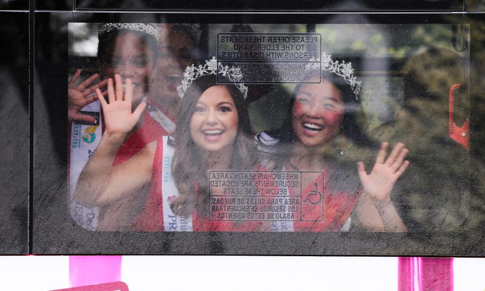 The Kentucky Derby Festival Princesses waved from a bus during the Pegasus Parade 2021 as they traveled near Atherton High School in Louisville, Ky. on Apr. 11, 2021.  They rode the bus instead of a traditional style parade wagon because of issues surrounding the coronavirus pandemic.