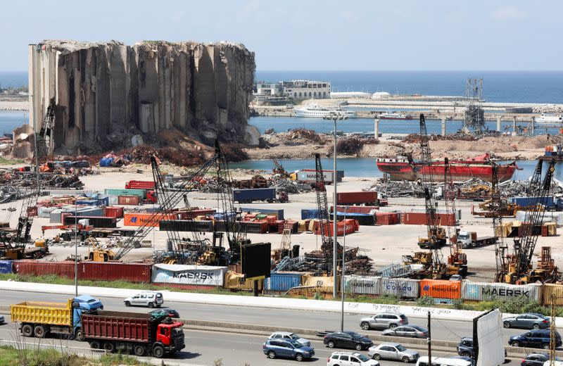 FILE PHOTO: Vehicles drive near the grain silo that was damaged during Beirut port explosion, in Beirut