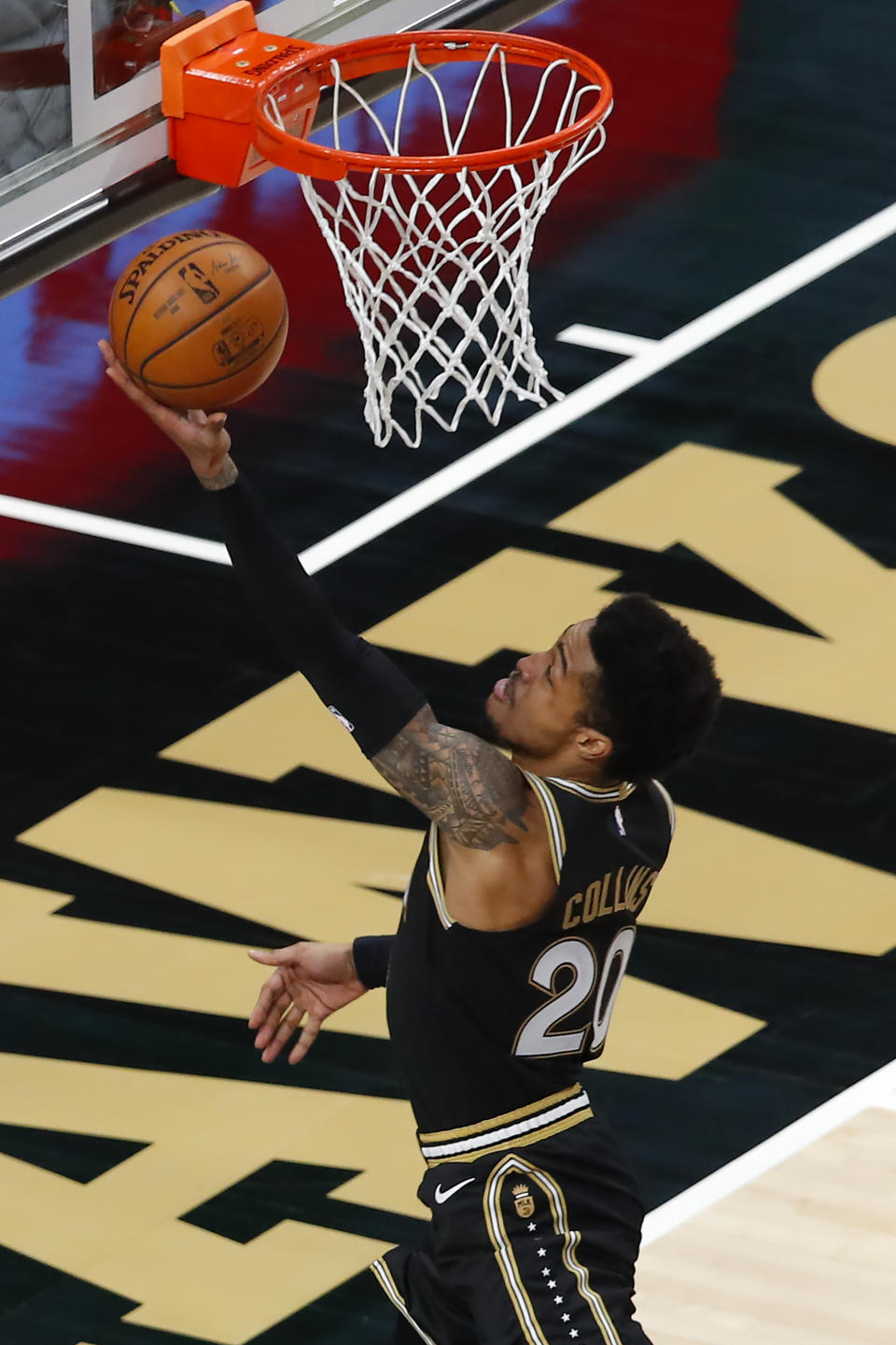 Atlanta Hawks forward John Collins (20) goes up for a shot in the first half of an NBA basketball game against the Minnesota Timberwolves on Monday, Jan. 18, 2021, in Atlanta. (AP Photo/Todd Kirkland)