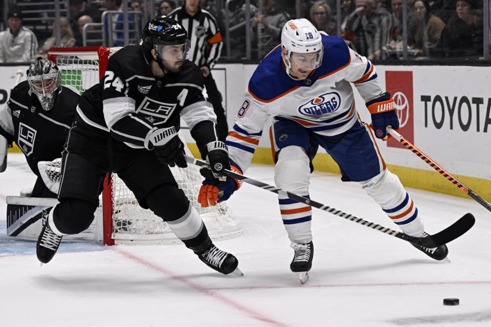 Los Angeles Kings center Phillip Danault (24) defends against Edmonton Oilers left wing Zach Hyman (18) from advancing the puck with goaltender David Rittich, left, in the net during the first period of an NHL hockey game in Los Angeles, Saturday, Feb. 10, 2024. (AP Photo/Alex Gallardo)
