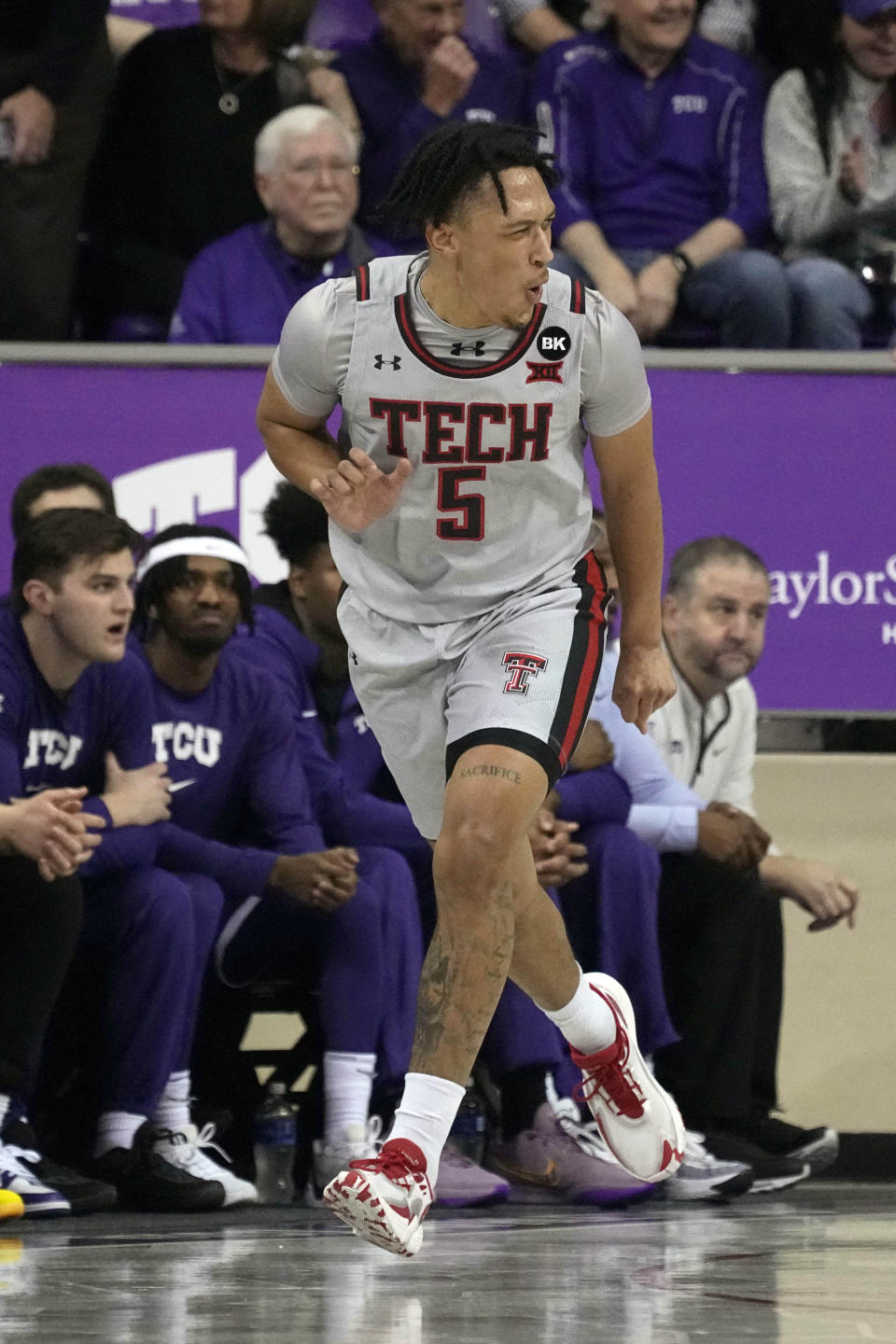 Texas Tech guard Darrion Williams celebrates after sinking a three-point basket in the first half of an NCAA college basketball game against TCU in Fort Worth, Texas, Tuesday, Jan. 30, 2024. (AP Photo/Tony Gutierrez)