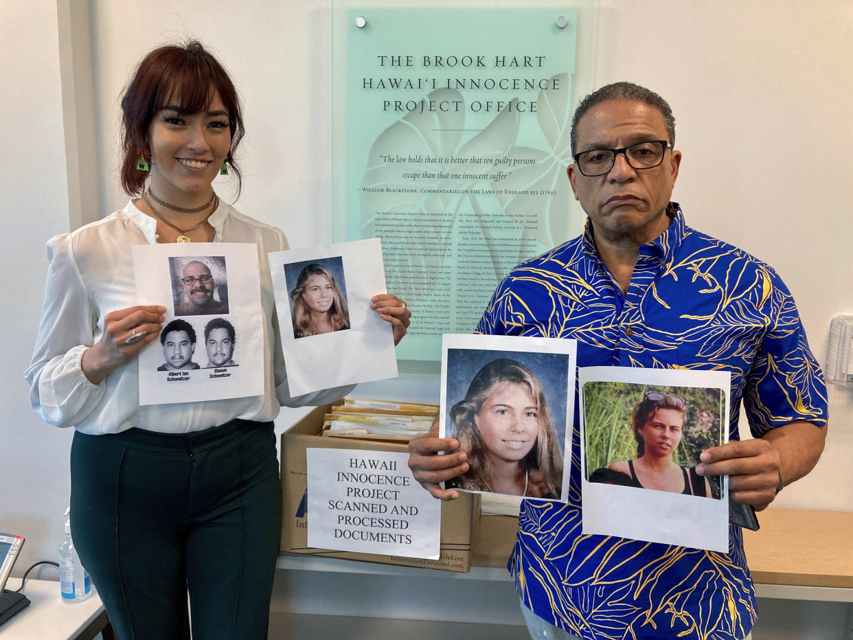 University of Hawaii law school student Skye Jansen, left, and Hawaii Innocence Project co-director Kenneth Lawson pose with photos related to the 1991 murder of Dana Ireland in Honolulu on Tuesday, Jan. 17, 2023. A petition filed Monday, Jan. 23 outlining new evidence in one of Hawaii's biggest criminal cases asks a judge to release Albert “Ian” Schweitzer, a Native Hawaiian man who has spent more than 20 years in prison for the sexual assault, kidnapping and murder of Ireland, a white woman, on the Big Island. (AP Photo/Jennifer Sinco Kelleher)