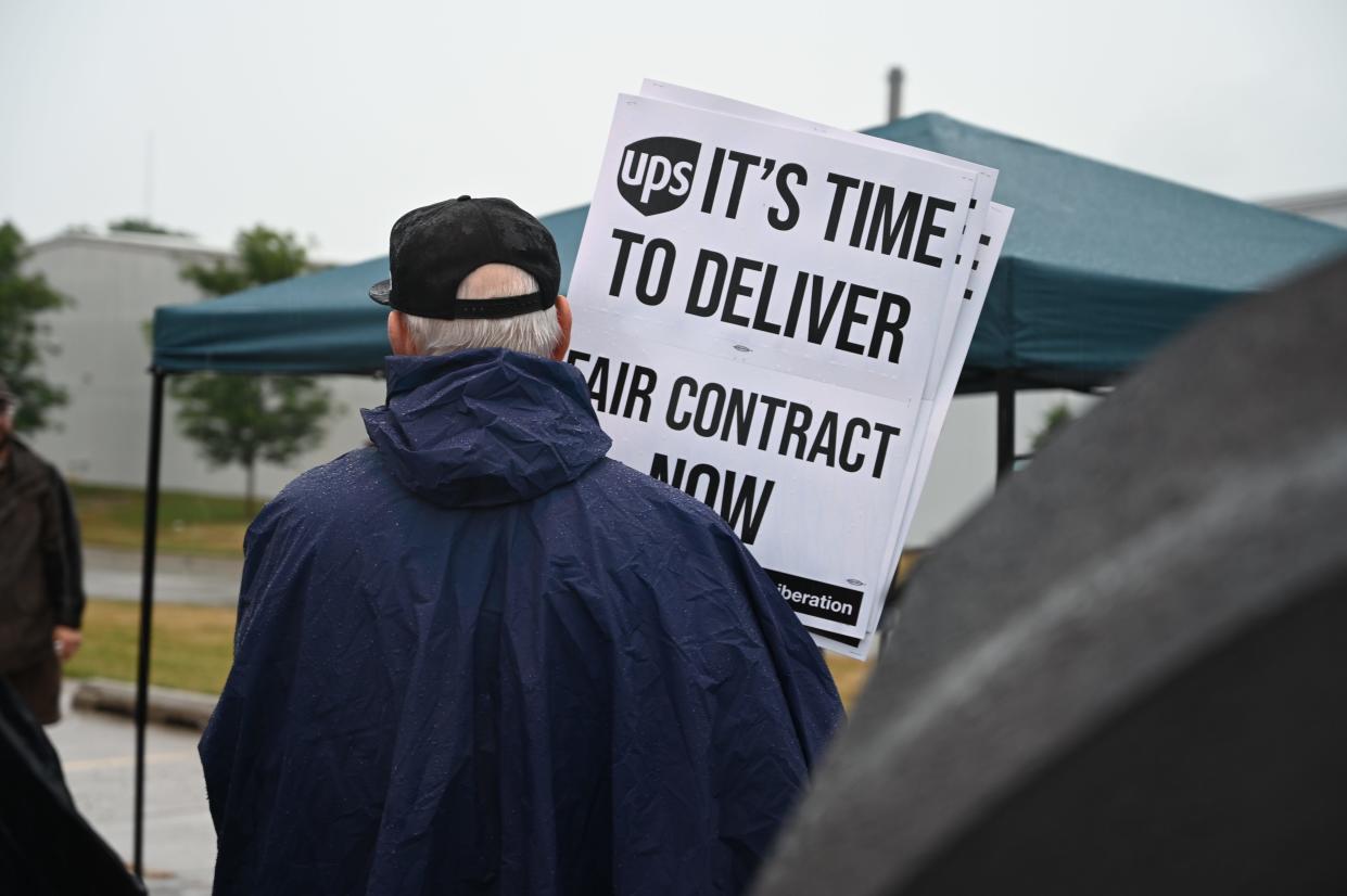 A member of Teamsters Local 90 pickets outside of a UPS Customer Center in Des Moines last summer