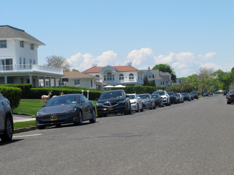 Cars are parked on an oceanfront street in Deal, N.J., on May 15, 2021. The Jersey shore town has introduced a law that would restrict parking on many streets closest to the ocean to residents-only. Some shore towns in New Jersey and other states have used parking restrictions as a way to keep outsiders off their beaches. (AP Photo/Wayne Parry)