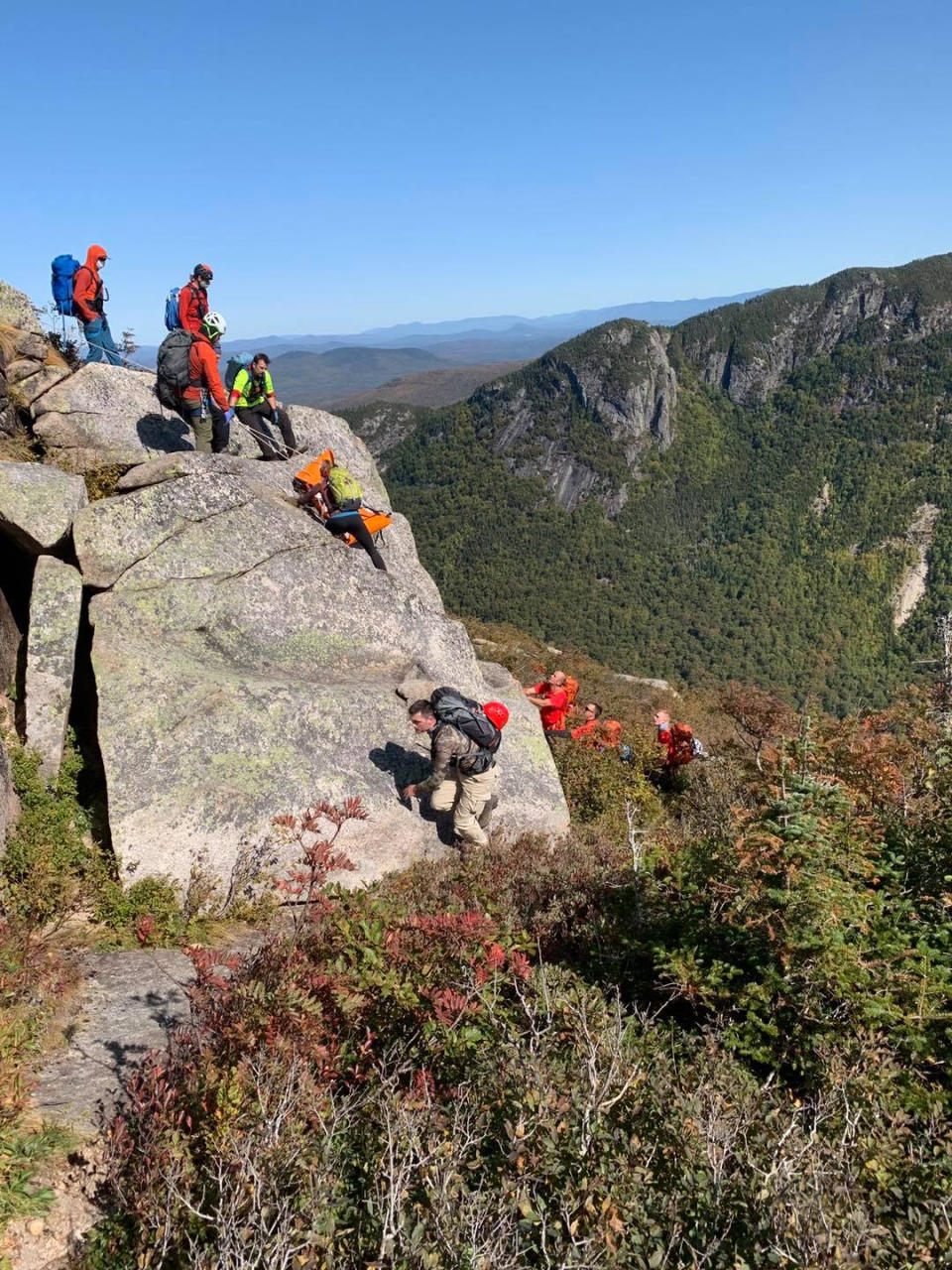 NH Fish and Game Conservation Officers, Mountain Rescue Service members and Pemi Valley Search and Rescue Team members look for a fallen climber in Franconia, N.H., on Sept. 21, 2020. (N.H. Fish and Game)