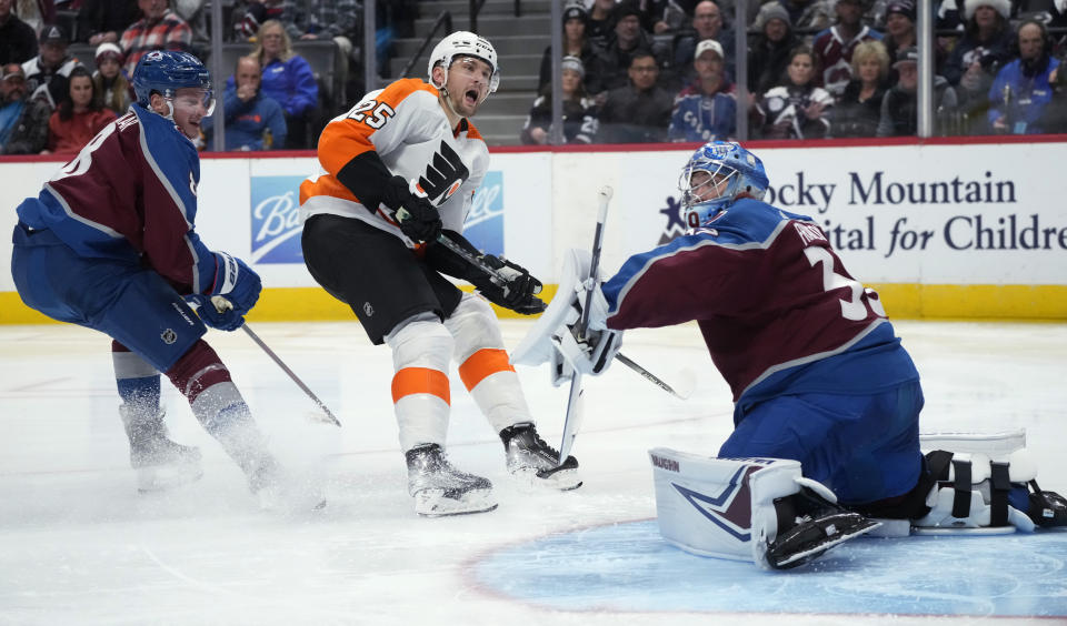 Philadelphia Flyers left wing James van Riemsdyk, center, reacts after his shot was deflected by Colorado Avalanche goaltender Pavel Francouz, right, as defenseman Cale Makar looks on in the second period of an NHL hockey game Tuesday, Dec. 13, 2022, in Denver. (AP Photo/David Zalubowski)