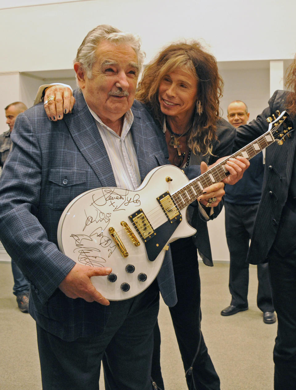 ALTERNATIVE CROP OF EDB102 - In this picture released by Uruguay's Press Office, President Jose Mujica, left, poses with Aerosmith's Steven Tyler after receiving an autographed guitar as a gift at the presidential house in Montevideo, Uruguay, Tuesday, Oct. 8, 2013. The band will perform Wednesday as part of their Latin America tour. (AP Photo/Uruguay Press Office, Alvaro Salas)