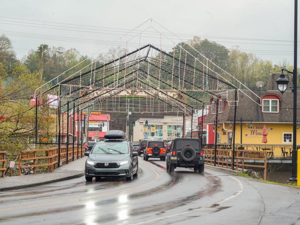 Cars drive through Pigeon Forge, a town outside of the national park.