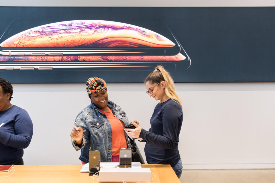 A customer (center-left) with an Apple store employee (center-right).