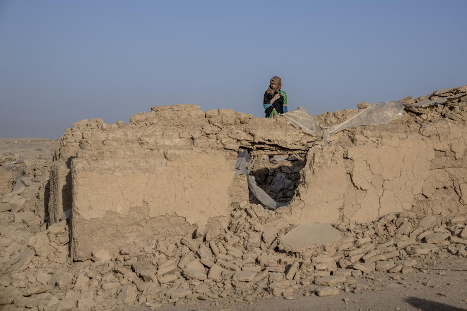 A girl stands amid rubble after an earthquake in Zenda Jan district in Herat province, western Afghanistan, Wednesday, Oct. 11, 2023. Another strong earthquake shook western Afghanistan on Wednesday morning after an earlier one killed more than 2,000 people and flattened whole villages in Herat province in what was one of the most destructive quakes in the country's recent history. (AP Photo/Ebrahim Noroozi)