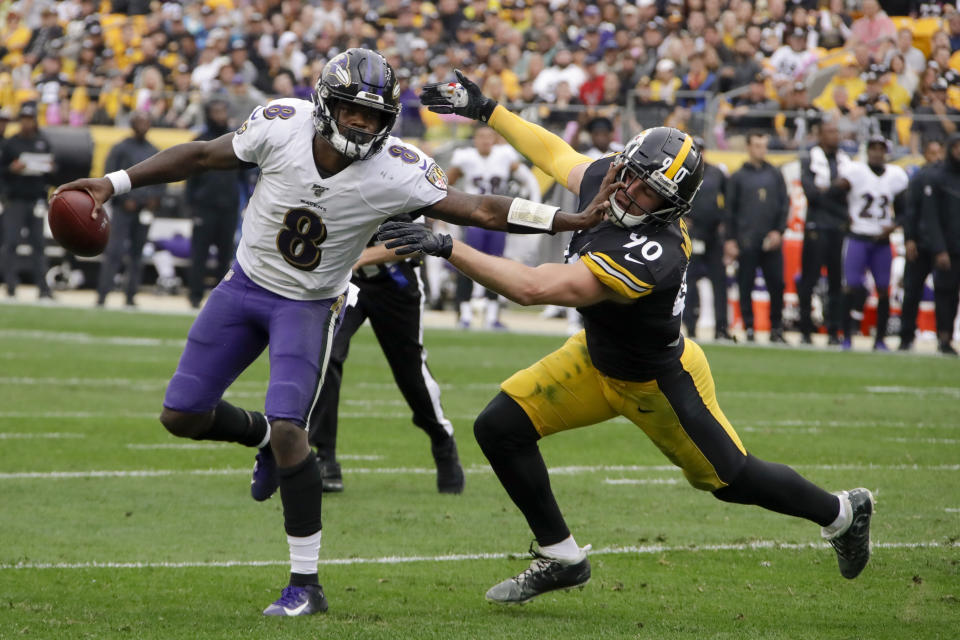 Baltimore Ravens quarterback Lamar Jackson (8) scrambles away from Pittsburgh Steelers outside linebacker T.J. Watt (90) in the first half of an NFL football game, Sunday, Oct. 6, 2019, in Pittsburgh. (AP Photo/Gene J. Puskar)