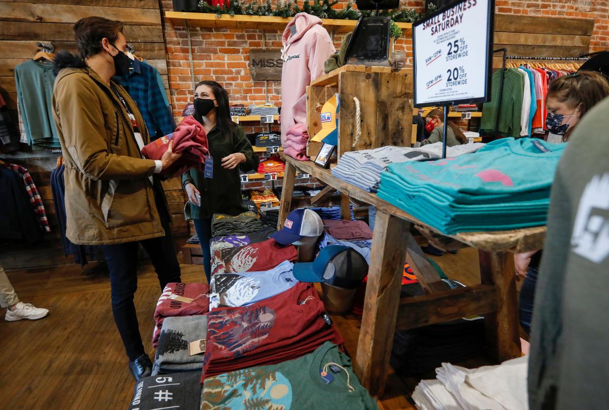 Brice Turner, left and Madison Davis shop at 5 Pound Apparel in downtown Springfield during Small Business Saturday on Saturday, Nov. 28, 2020.