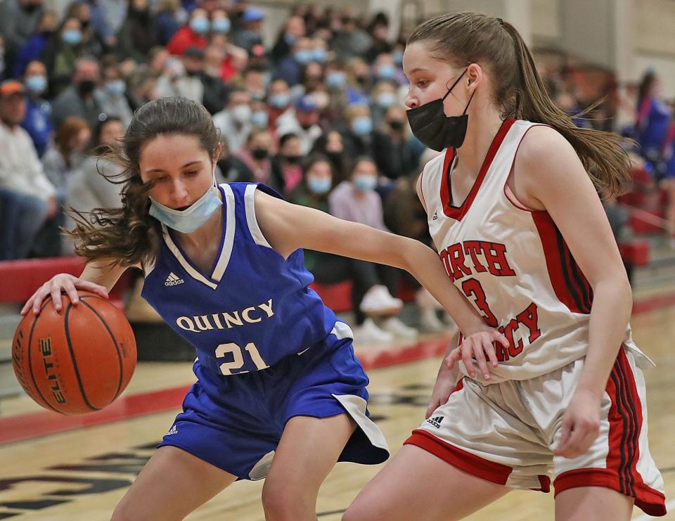 North Quincy's Orlagh Gormley, right, defends against Quincy's Caroline Campbell. North Quincy hosted Quincy in girls basketball on Friday. Jan. 21, 2022.