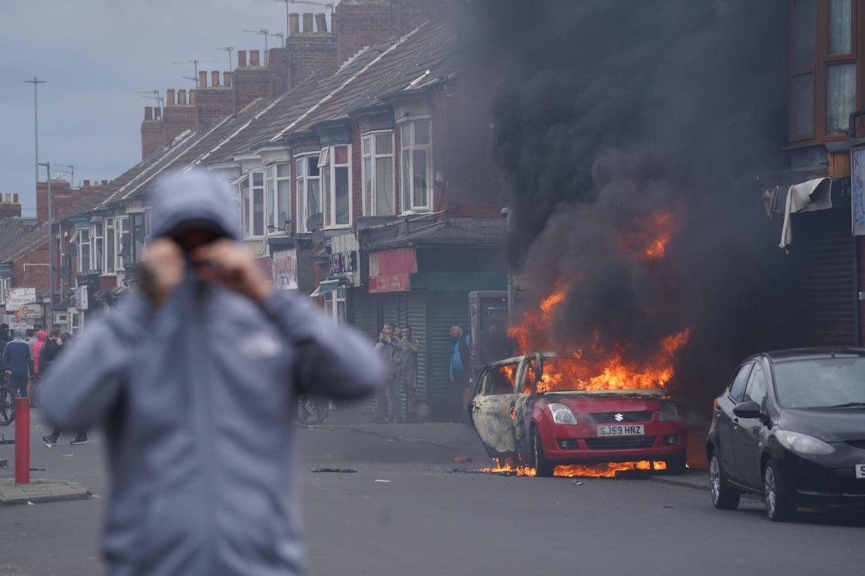 A car burns during an anti-immigration protest in Middlesbrough. Picture date: Sunday August 4, 2024.