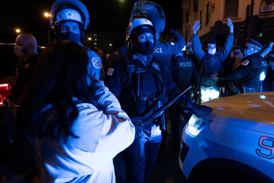Protesters confront Chicago Police following a march for 13-year-old Adam Toledo Friday April 15, 2021 in Chicago's Logan Square neighborhood.