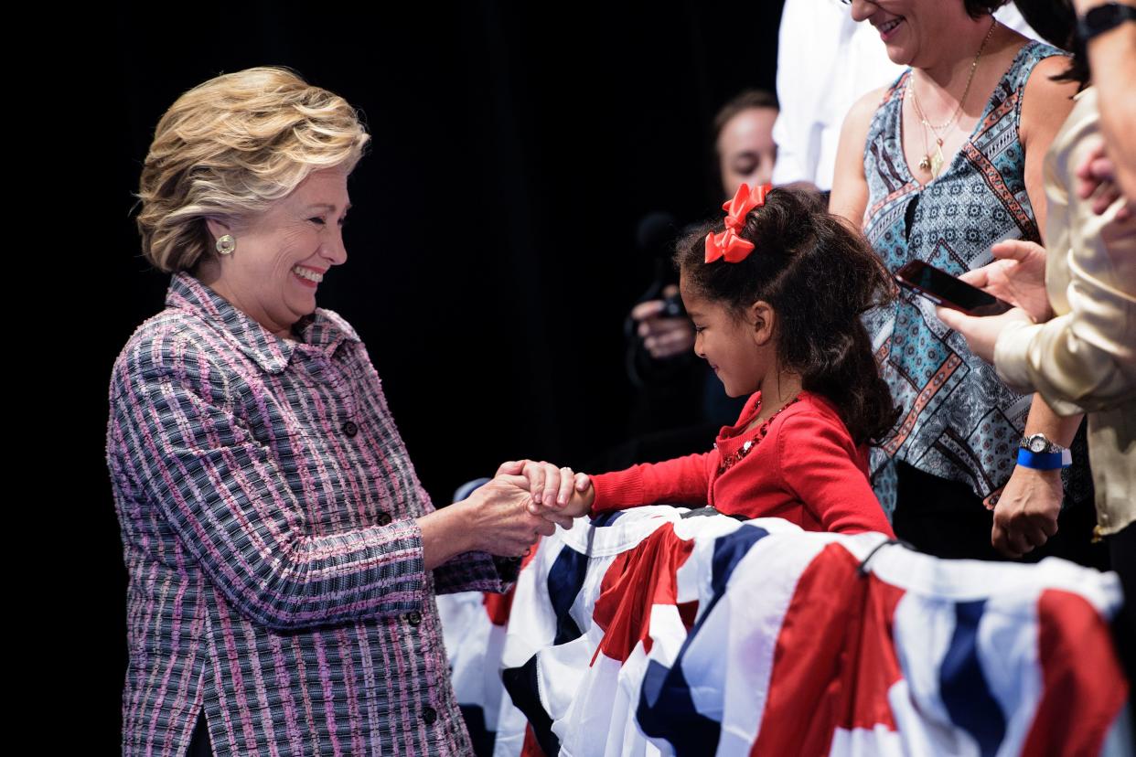 Hillary Clinton meets a child during her presidential run at the Sunrise Theatre in Fort Pierce, Florida. (Photo: BRENDAN SMIALOWSKI via Getty Images)
