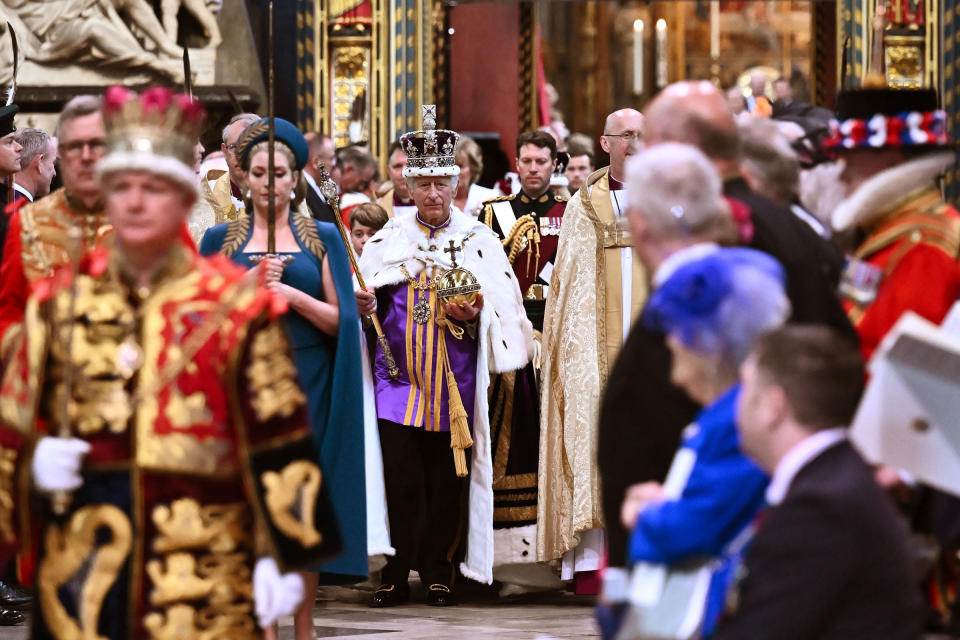 King Charles III wearing the Imperial state Crown carrying the Sovereign's Orb and Sceptre leaves Westminster Abbey after the Coronation ceremony.<span class="copyright">2023 Getty Images</span>