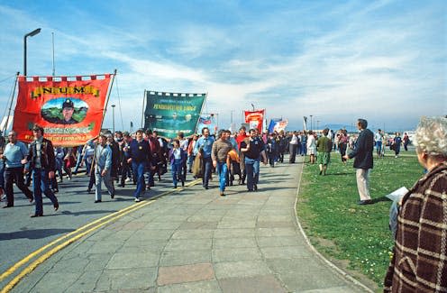 <span class="caption">Miners from different collieries gather in Port Talbot in April 1984.</span> <span class="attribution"><a class="link " href="https://www.flickr.com/photos/alandenney/2457055287" rel="nofollow noopener" target="_blank" data-ylk="slk:Alan Denney/Flickr;elm:context_link;itc:0;sec:content-canvas">Alan Denney/Flickr</a>, <a class="link " href="http://creativecommons.org/licenses/by-nc/4.0/" rel="nofollow noopener" target="_blank" data-ylk="slk:CC BY-NC;elm:context_link;itc:0;sec:content-canvas">CC BY-NC</a></span>