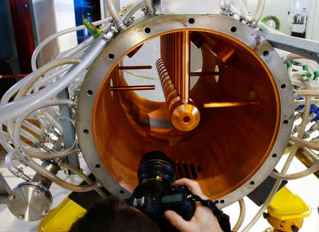 A photographer takes a picture of the inside of a prototype of a drift tube of the new linear accelerator Linac 4, the newest accelerator acquisition since the Large Hadron Collider (LHC), which is due to feed the CERN accelerator complex with particle beams of higher energy, during its inauguration at the European Organization for Nuclear Research (CERN) in Meyrin near Geneva, Switzerland, May 9, 2017. REUTERS/Denis Balibouse