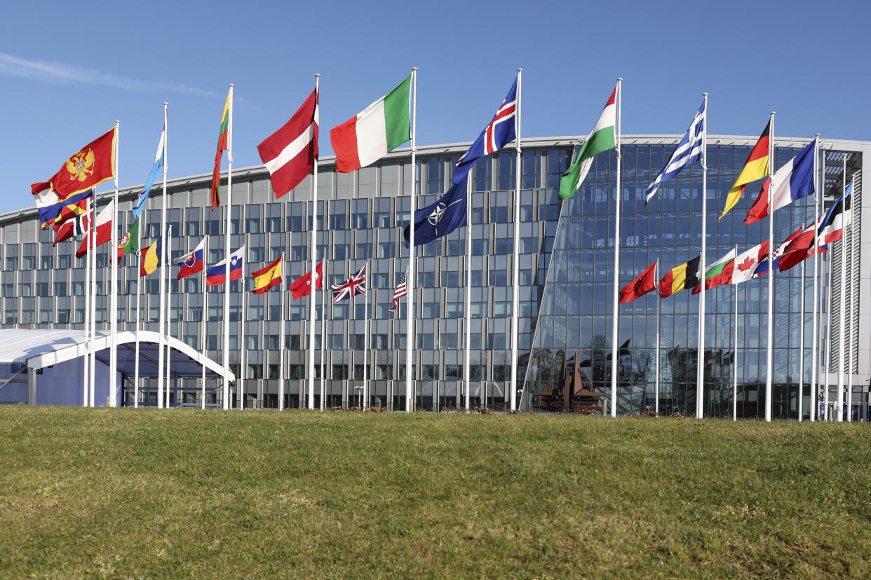 Flags of member nations flap in the wind outside NATO headquarters during a meeting of NATO foreign ministers in Brussels, Tuesday, April 4, 2023. (AP Photo/Geert Vanden Wijngaert)