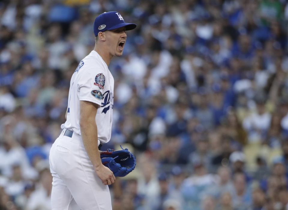 Los Angeles Dodgers' Walker Buehler reacts after getting Milwaukee Brewers' Ryan Braun to strike out during the third inning of Game 3 of the National League Championship Series baseball game Monday, Oct. 15, 2018, in Los Angeles. (AP Photo/Jae Hong)