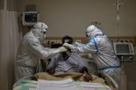 Medical workers treat patients infected with the coronavirus disease (COVID-19) at a hospital in New Delhi