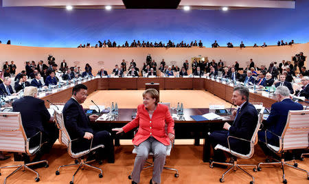 FILE PHOTO: (L-R) US President Donald Trump, China's President Xi Jinping, German Chancellor Angela Merkel, Argentinia's President Mauricio Macri and Australia's Prime Minister Malcolm Turnbull turn around for photographers at the start of the first working sessionthe G20 summit in Hamburg, Germany, July 7, 2017. REUTERS/John MACDOUGALL/POOL/File Photo