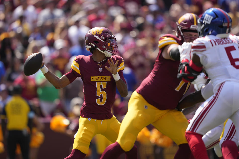 Washington Commanders quarterback Jayden Daniels (5) looks to pass against the New York Giants during the first half of an NFL football game in Landover, Md., Sunday, Sept. 15, 2024. (AP Photo/Matt Slocum)