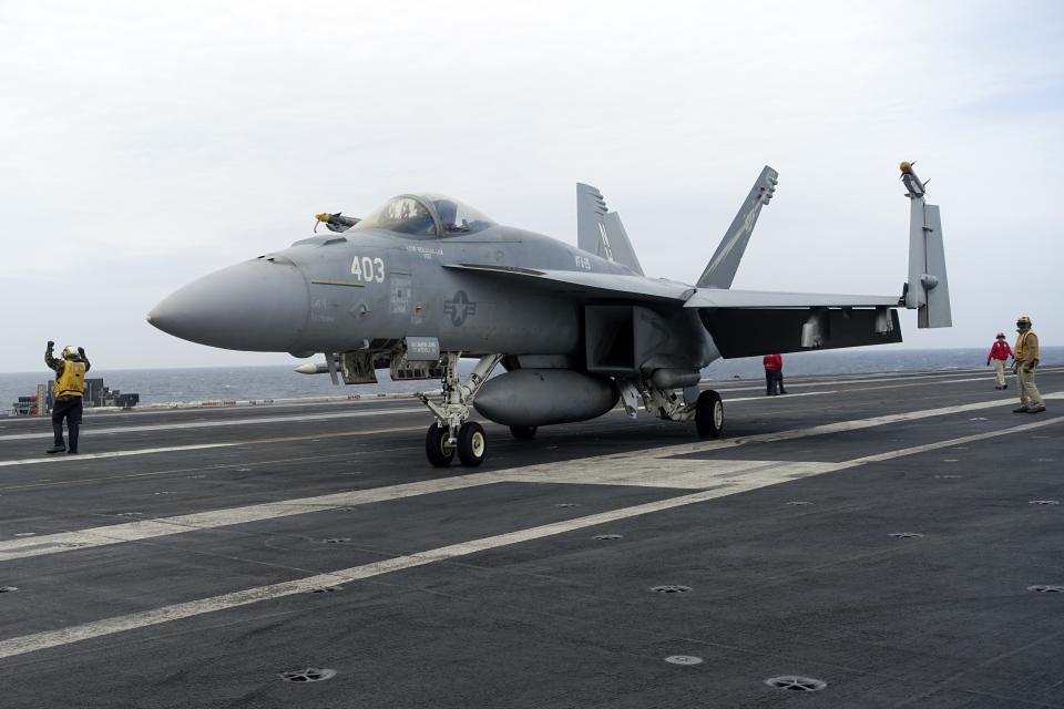 A F-18E parks on the flight deck of a USS Theodore Roosevelt aircraft carrier on Thursday, April 11, 2024 during a three-day joint naval exercise by the U.S., Japanese and South Korea at the East China Sea amid tension from China and North Korea. (AP Photo/Mari Yamaguchi)