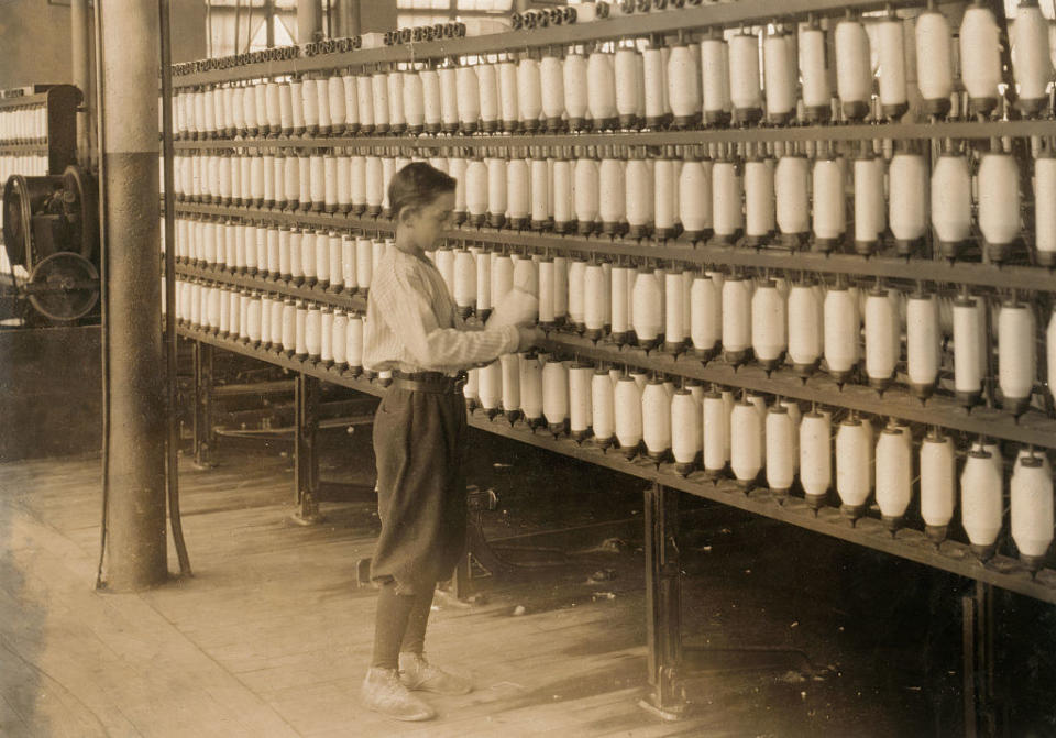 a 14-year-old works the large spinning machines