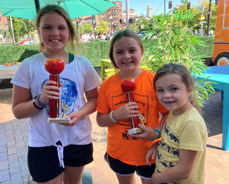 From left, the O'Dwyer sisters, Maddie, 12, Rachel, 9, and Charlotte, 7, show off their tomato trophies after winning and placing in two tomato categories; slicing won first, heaviest won second. They help their parents, Kevin and Kate, at Langwater Farm in North Easton.