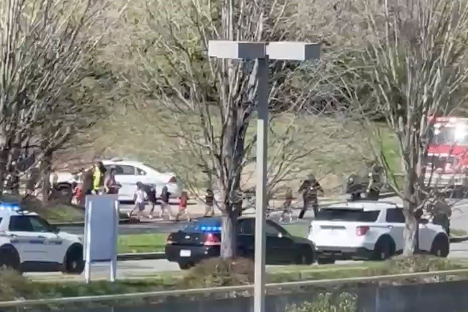 In this image from video provided by Jozen Reodica, law enforcement officers lead children away from the scene of a shooting at The Covenant School, a private Christian school in Nashville, Tennessee. (AP)