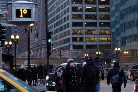 Pedestrians cross the street at rush hour, as bitter cold phenomenon called the polar vortex has descended on much of the central and eastern United States, in Chicago, Illinois, U.S., January 29, 2019. REUTERS/Pinar Istek