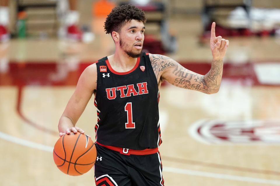 Utah Utes forward Timmy Allen (1) handles the ball during the second half against the Stanford Cardinal at Maples Pavilion.