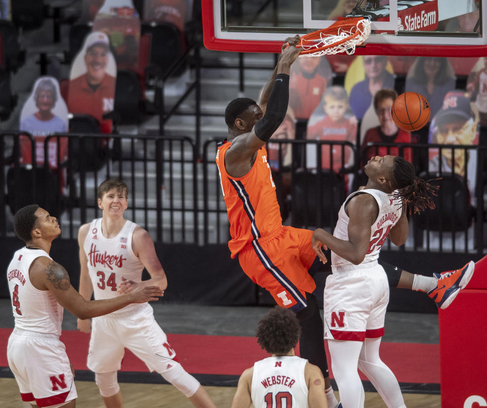 Illinois' Kofi Cockburn (21) dunks over Nebraska forward Yvan Ouedraogo (24) as Nebraska's Shamiel Stevenson (4), Thorir Thorbjarnarson (34) and Kobe Webster (10) watch during the first half of an NCAA college basketball game on Friday, Feb. 12, 2021, in Lincoln, Neb. (Francis Gardler/Lincoln Journal Star via AP)