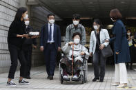 Former South Korean comfort woman Lee Yong-soo in a wheelchair leaves the Seoul Central District Court in Seoul, South Korea, Wednesday, April 21, 2021. The court on Wednesday rejected a claim by South Korean sexual slavery victims and their relatives who sought compensation from the Japanese government over their wartime sufferings. (AP Photo/Ahn Young-joon)