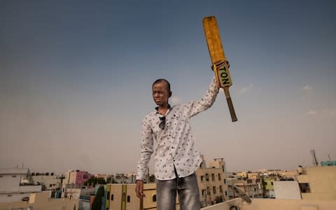 Ameer Hamza, 14, received cornea transplants in both eyes due to XP. He goes out some evenings at sunset to play cricket and is photographed playing on the roof of his building where he is away from stares and bullying - Credit: Simon Townsley/The Telegraph
