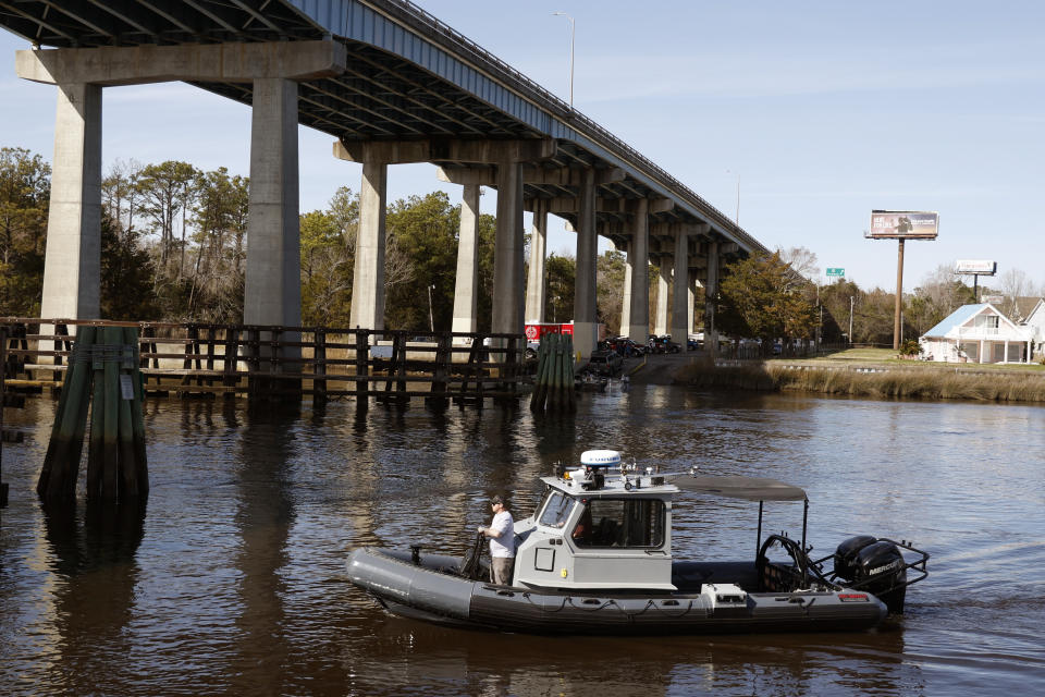 A Navy boat prepares to dock on the InterCoastal Waterway in North Myrtle Beach, S.C., Tuesday, Feb. 7, 2023. Using underwater drones, warships and inflatable vessels, the Navy is carrying out an extensive operation to gather all of the pieces of the massive Chinese spy balloon a U.S. fighter jet shot down off the coast of South Carolina on Saturday. (AP Photo/Nell Redmond)